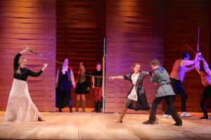 Capulet and Montague fight, while their husbands hold the women back