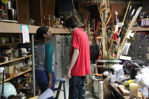 Searching the Prop Room for the list of objects they need